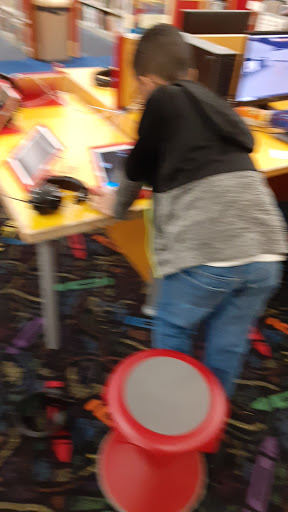 A child engaged in activities at a colorful indoor play area.