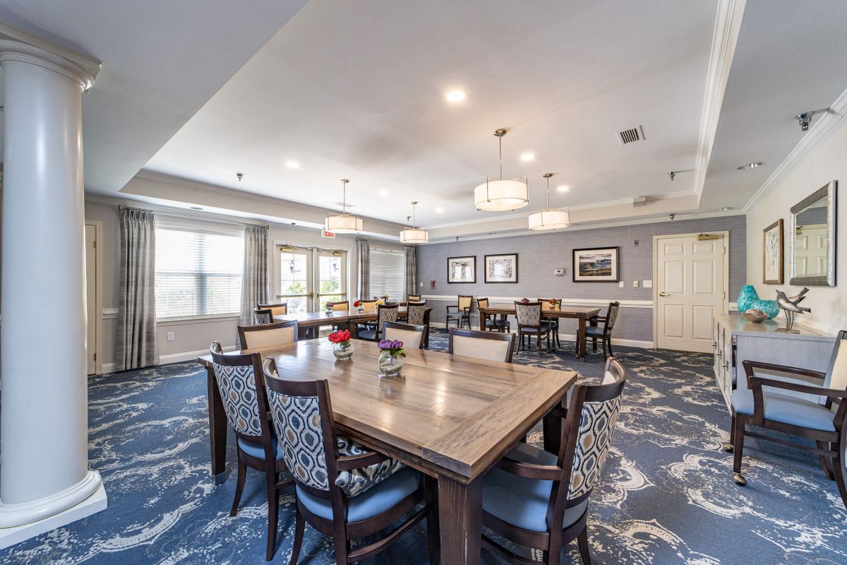 A modern dining room with elegant furnishings and ambient lighting.