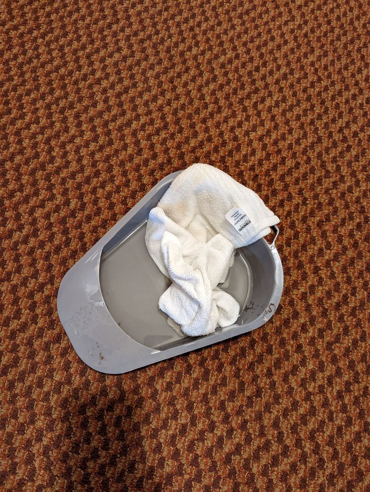 A white cap lying on a brown textured floor.