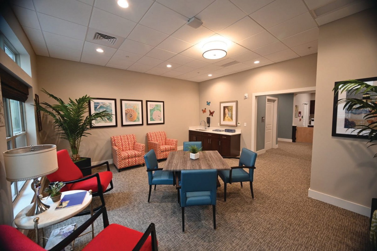 A modern lounge area with comfortable seating and artwork on the walls.