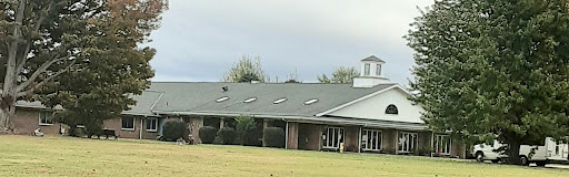 A view of a building with skylights under a cloudy sky.
