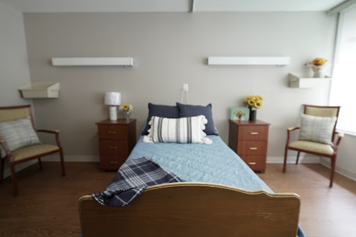 A well-furnished and cozy bedroom with a neatly made bed, stylish pillows, and warm lighting.