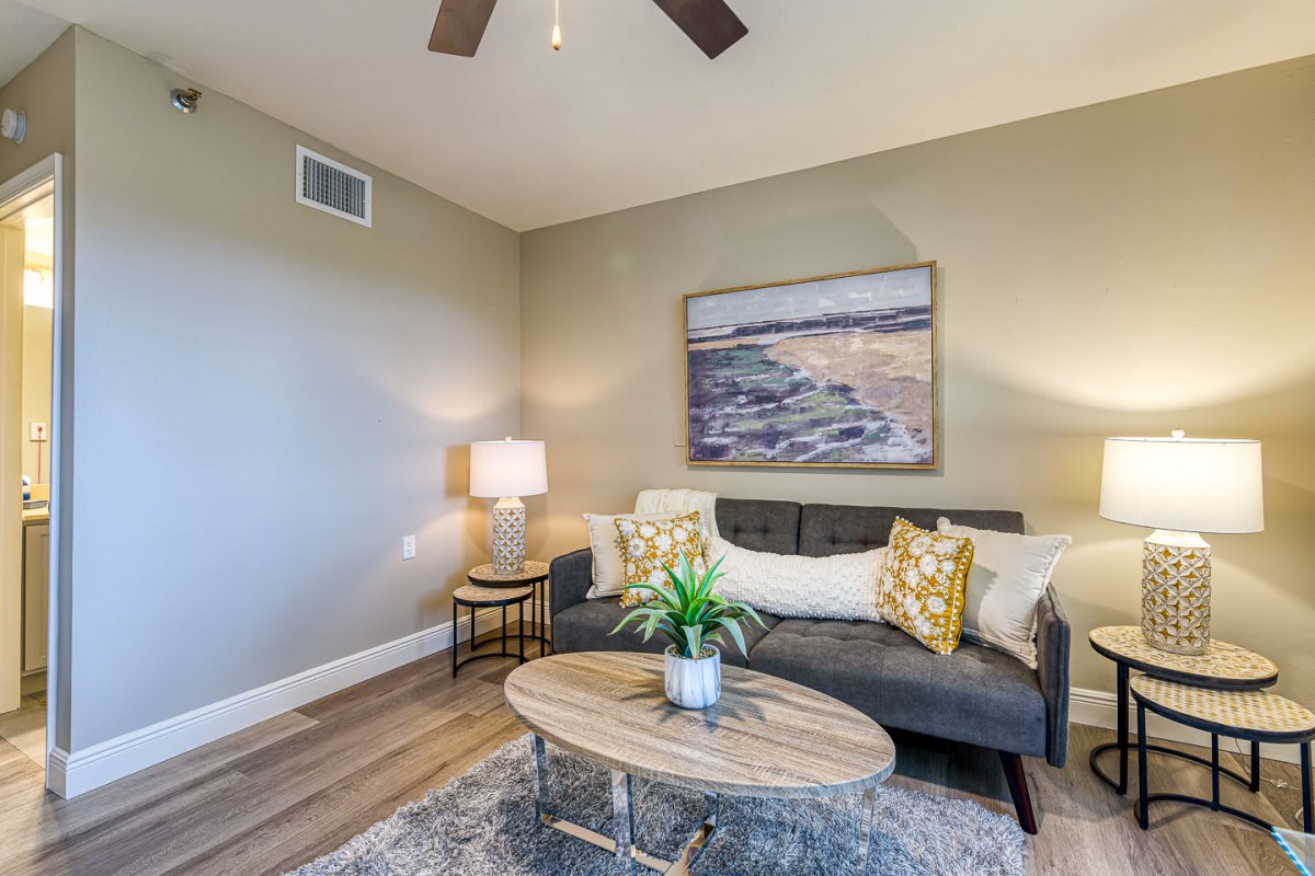 A cozy living room with a sofa, coffee table, and stylish decor.