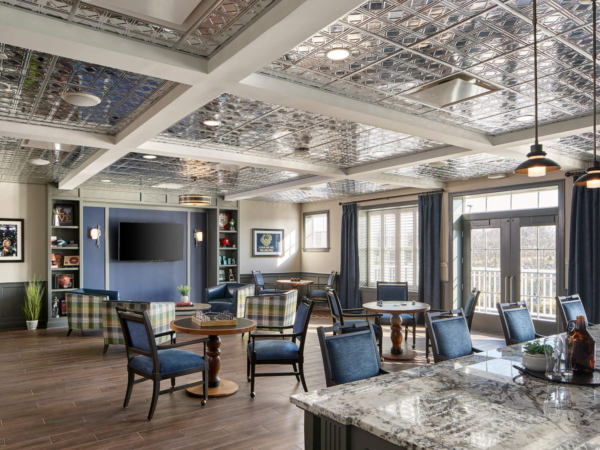 A beautifully decorated lounge with elegant seating and intricate ceiling design.