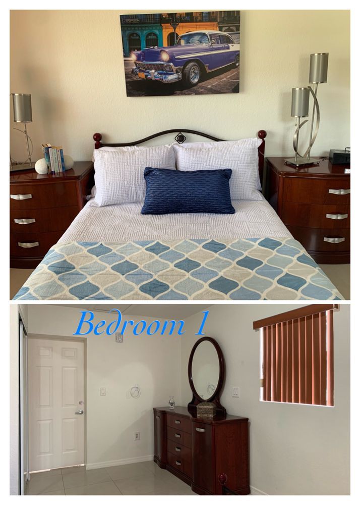A cozy bedroom with a neatly made bed, featuring bedside tables and a mirror.