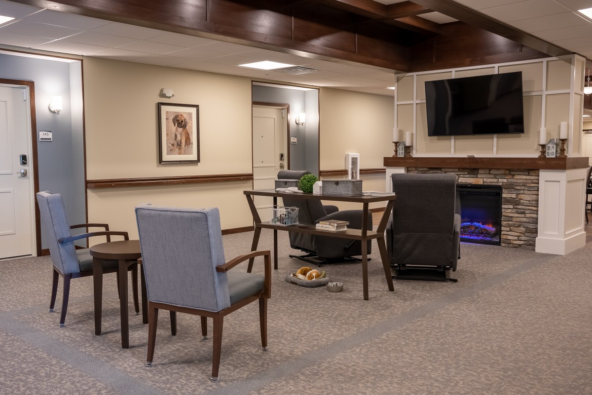 A modern living room space with comfortable seating and a large TV.
