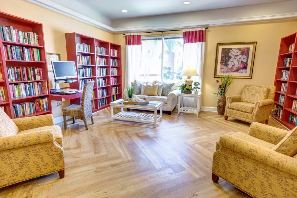 A cozy living room with a bookshelf and comfortable seating.