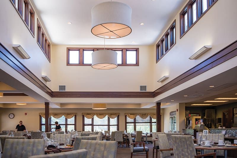 Spacious dining area with modern lighting and ample seating.