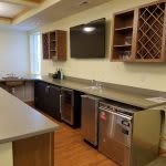 Modern kitchen with sleek appliances and a built-in wine rack.