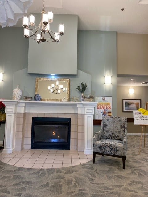 A cozy room with a fireplace, chandelier, and elegant decor.