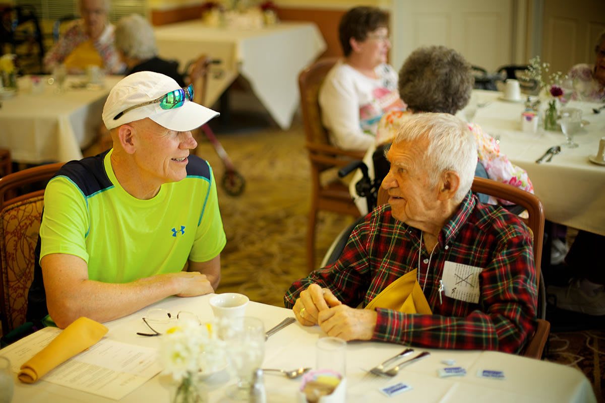 Two people enjoying a conversation at a dining table.