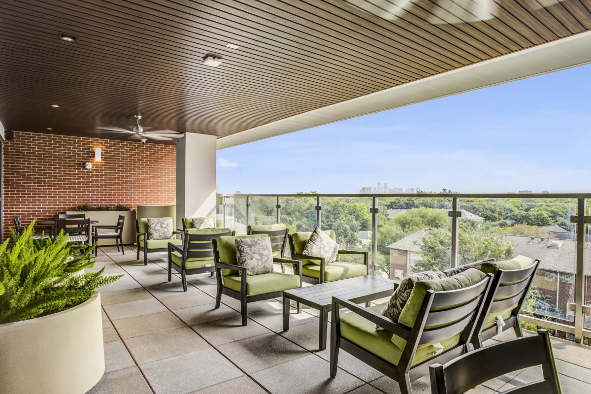 A modern balcony with comfortable seating and a scenic view.