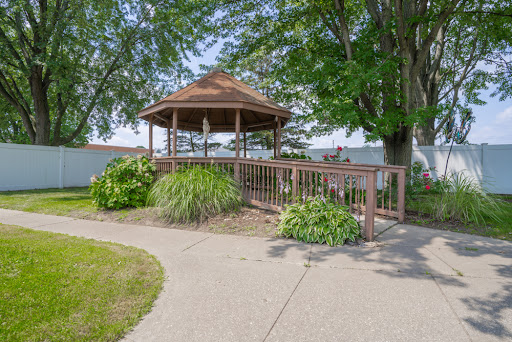 A charming gazebo surrounded by greenery, offering a peaceful spot to relax in nature.