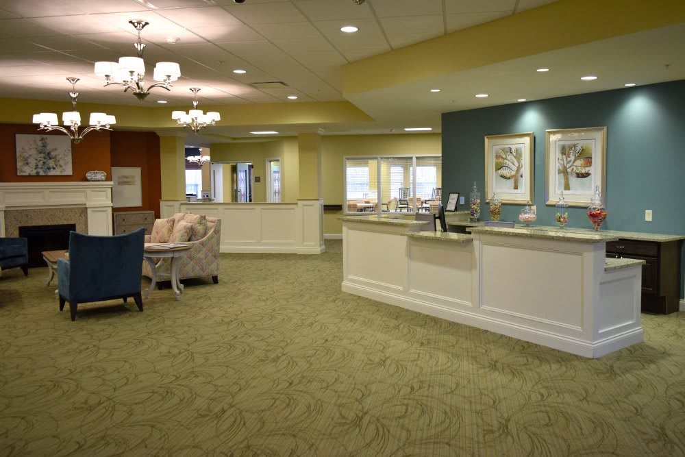 A well-lit lobby with a reception desk and comfortable seating.
