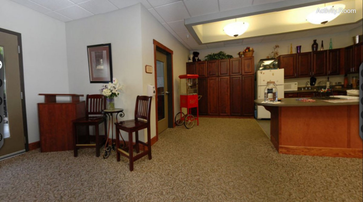 A cozy waiting room with chairs, a table, and decorative elements.