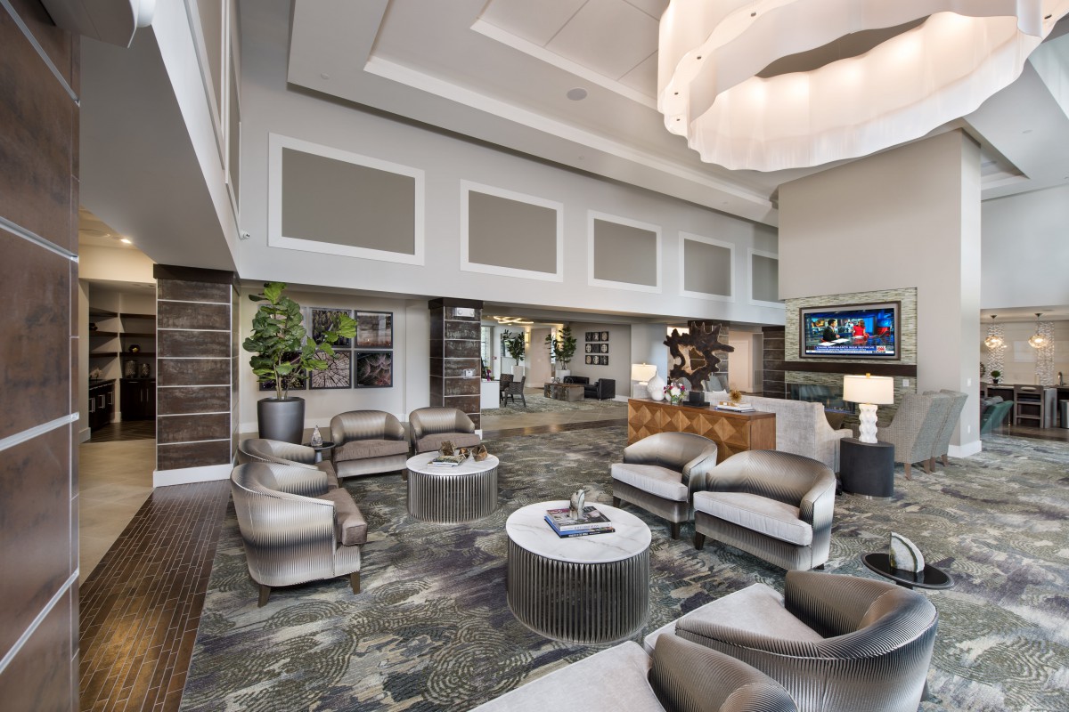 A luxurious modern living room with high ceilings and elegant furniture.