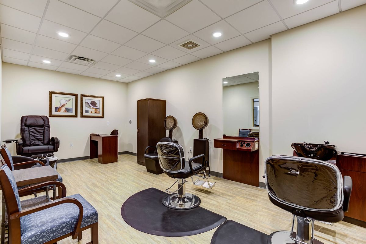 Modern hair salon interior with styling chairs and equipment.