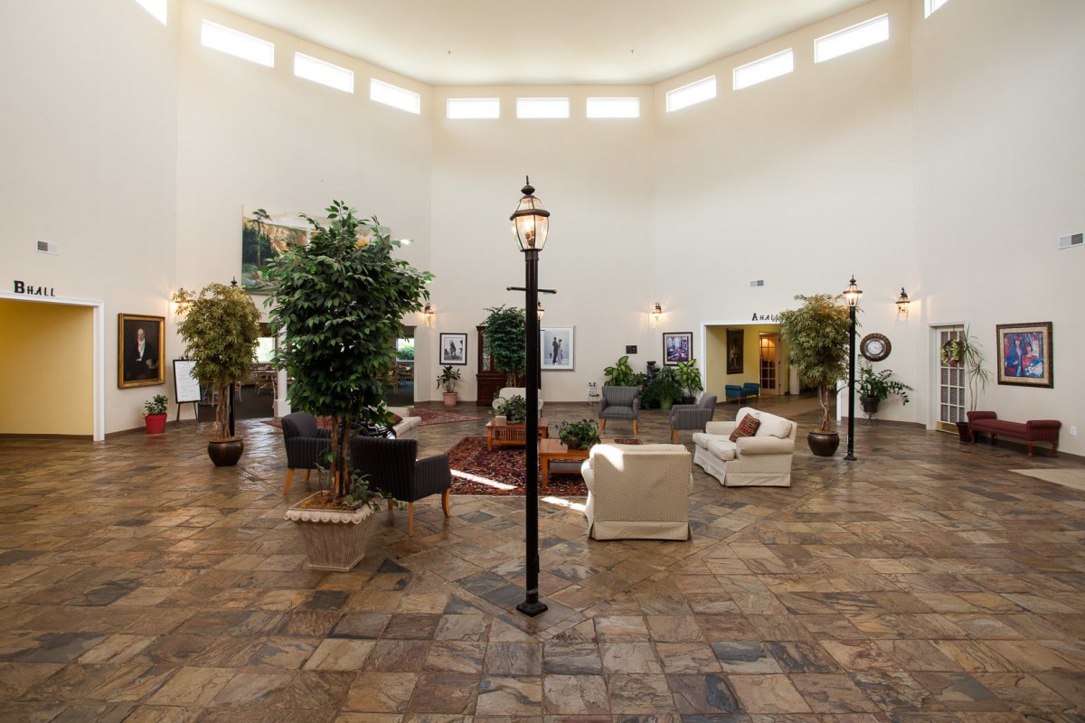 A spacious lobby area with comfortable seating and decorative plants.