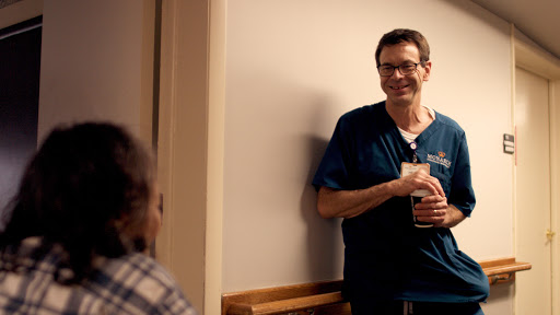 A healthcare professional engages with a patient in a warm and friendly manner.