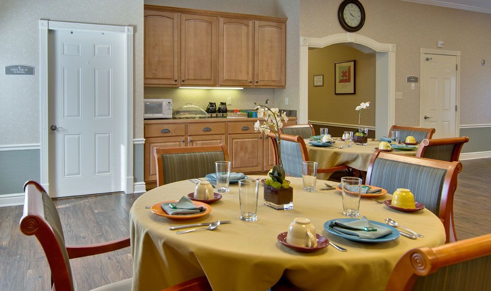 A cozy dining area with a neatly set table and a view into the kitchen.