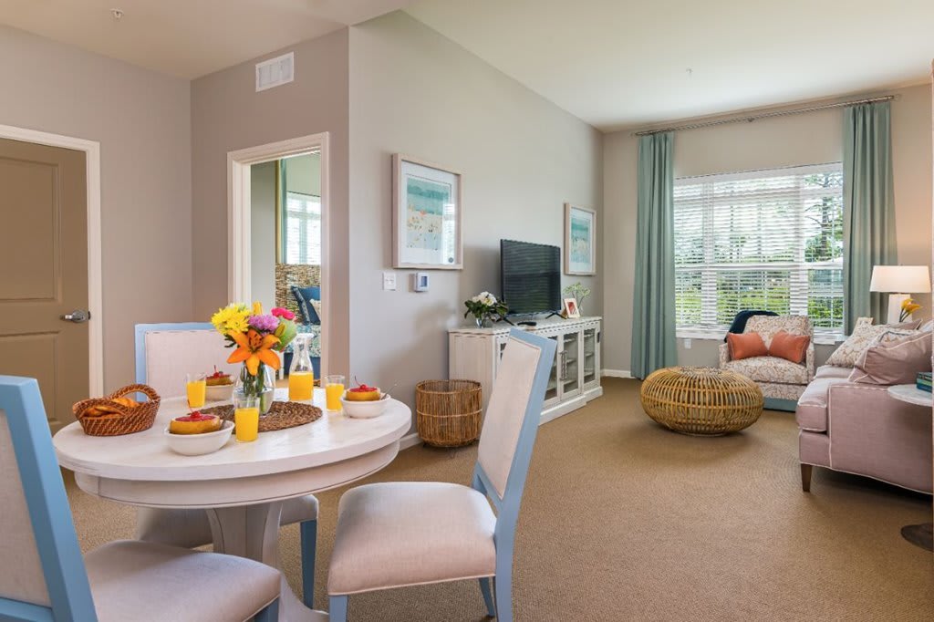 A bright and cozy living space featuring a modern dining area and a comfortable seating arrangement.