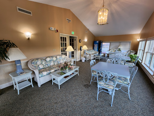A cozy lounge area featuring comfortable sofas and elegant tables, perfect for relaxation and gatherings.