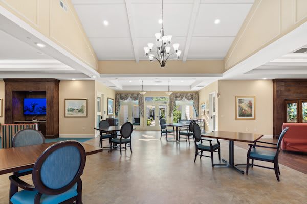 A spacious lobby area with elegant furnishings and a chandelier.