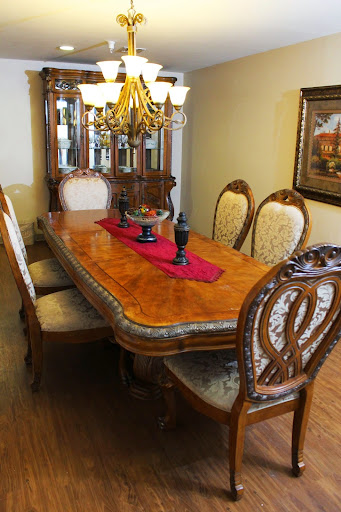 A beautifully arranged dining room with a classic wooden dining table and elegant chairs.