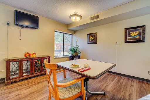 A cozy dining area featuring a table and chairs, complemented by a television and decorative elements.