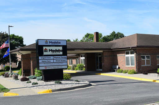 A view of a healthcare facility with clear signage and landscaping on a sunny day.