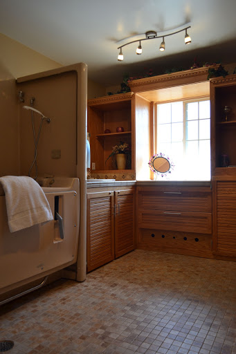 A beautifully designed bathroom featuring wooden cabinetry and a spacious layout.