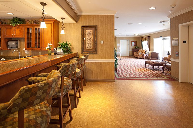 A cozy lounge area featuring a bar with seating and modern decor.