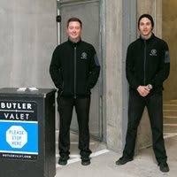 Valet service employees standing at the entrance, ready to assist.