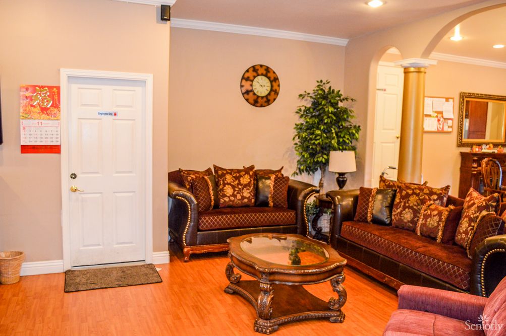 A cozy living room with brown sofas, a wooden coffee table, and warm decor.