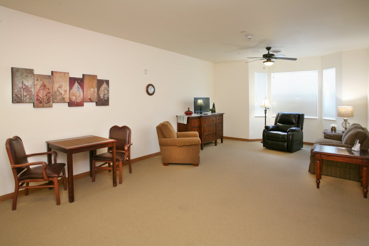 A minimalist living room with comfortable seating and a TV.