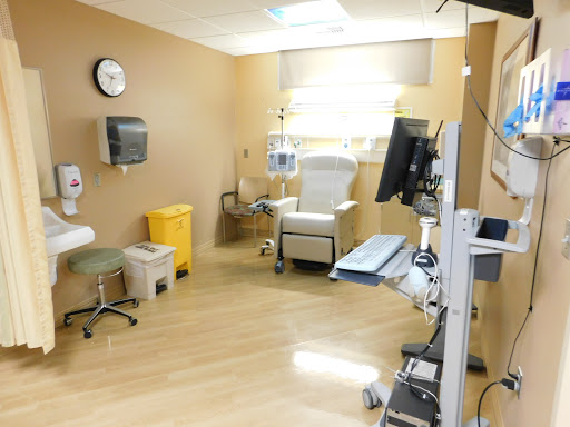 A clean and well-organized patient room in a hospital, equipped for medical care.