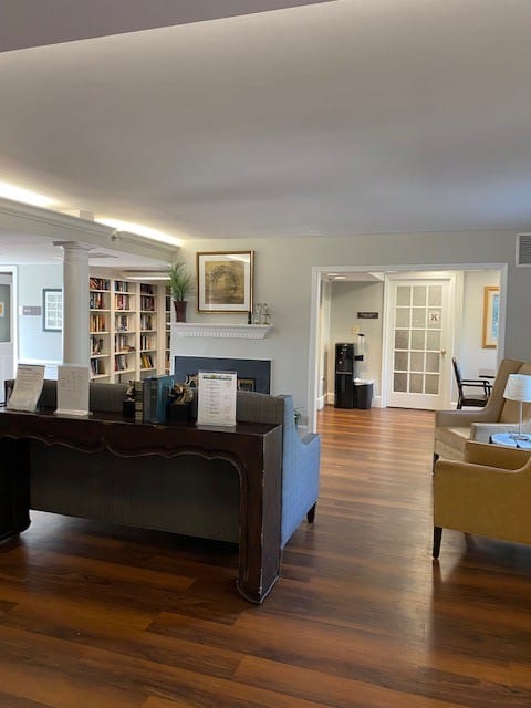 A cozy living room with bookshelves and comfortable seating arrangements.