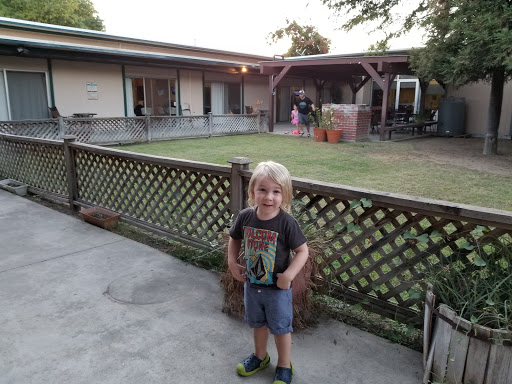 A cheerful child enjoying an evening outdoors.