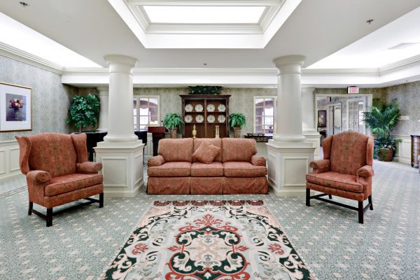 A traditionally decorated living room with comfortable seating and elegant columns.