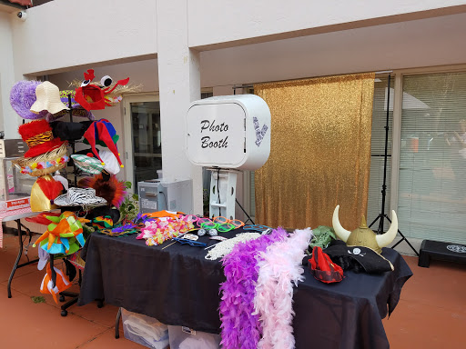 A vibrant photo booth setup featuring a variety of colorful props and accessories for a fun party atmosphere.