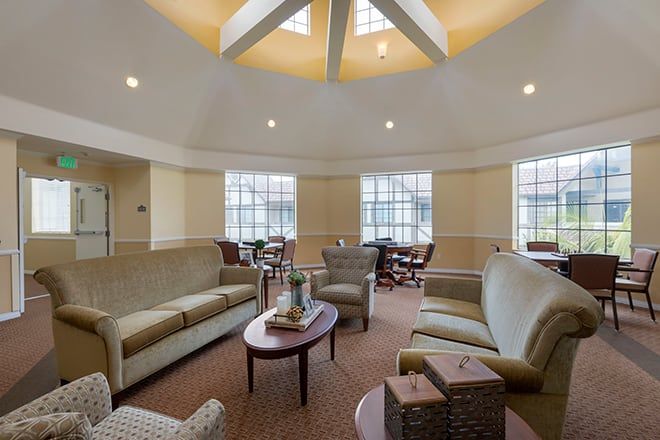 A spacious living room with comfortable seating, large windows, and a stylish coffee table.