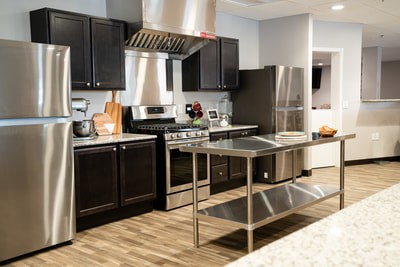 A modern kitchen with stainless steel appliances and a central island.