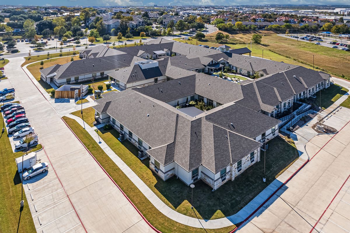 Aerial view of a large building complex in a suburban area.