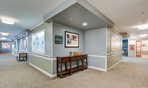 A well-decorated hallway with a wooden console table and framed artwork.