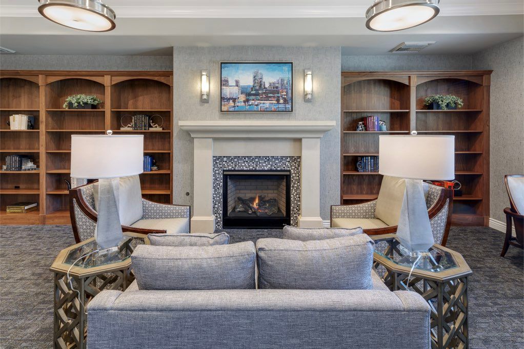A modern living room featuring a cozy fireplace and stylish furniture.