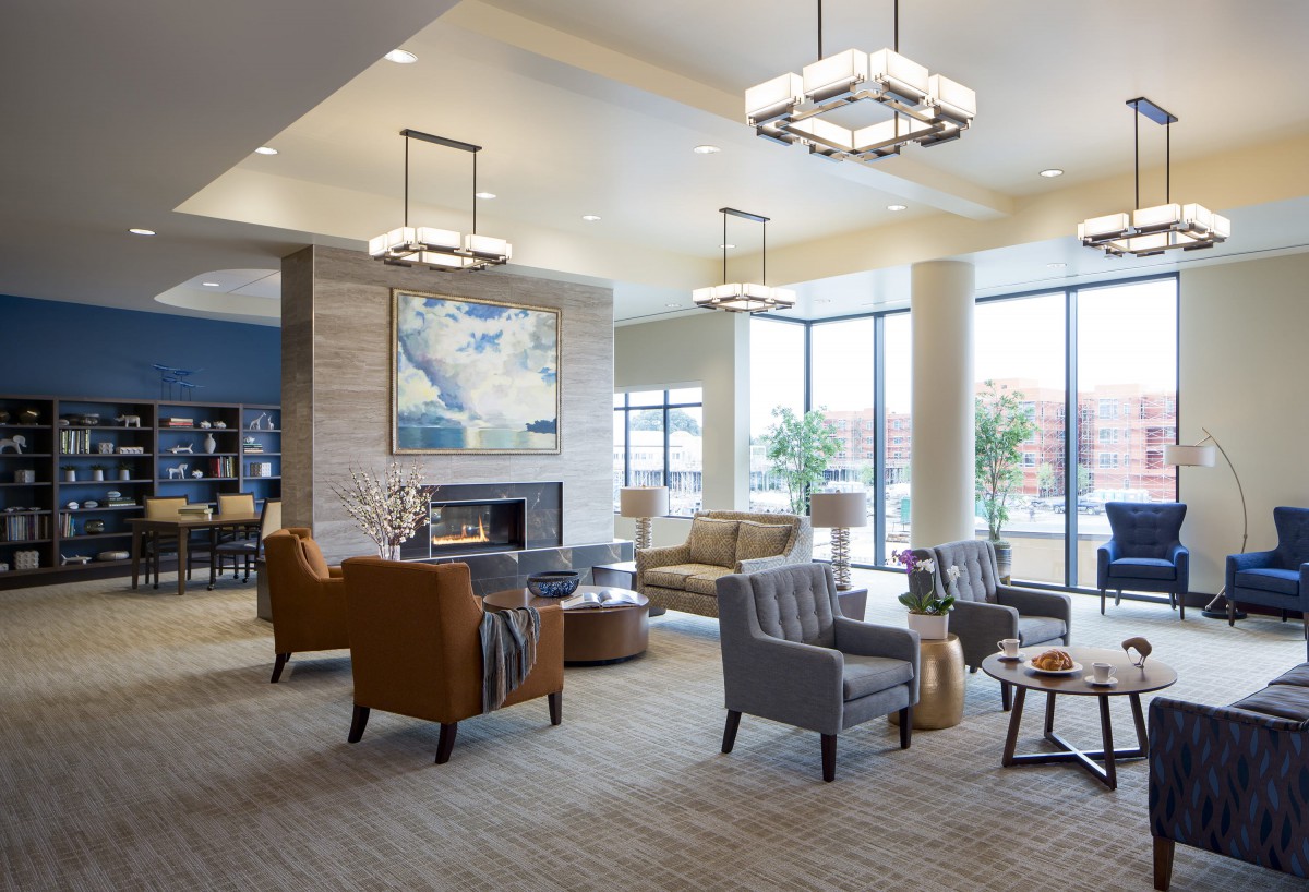A modern lobby with comfortable seating, large windows, and elegant lighting.