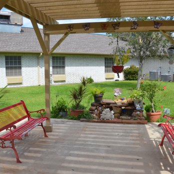 A cozy outdoor patio area with seating and beautifully arranged plants, perfect for relaxation.
