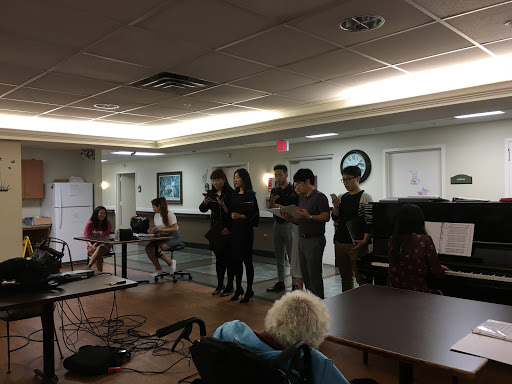 A group of performers presenting in front of an audience during a community event.