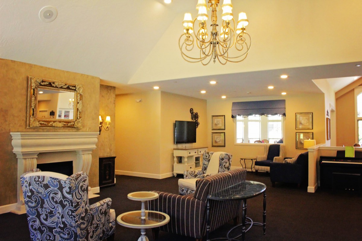 A cozy living room with elegant decor and a large chandelier.
