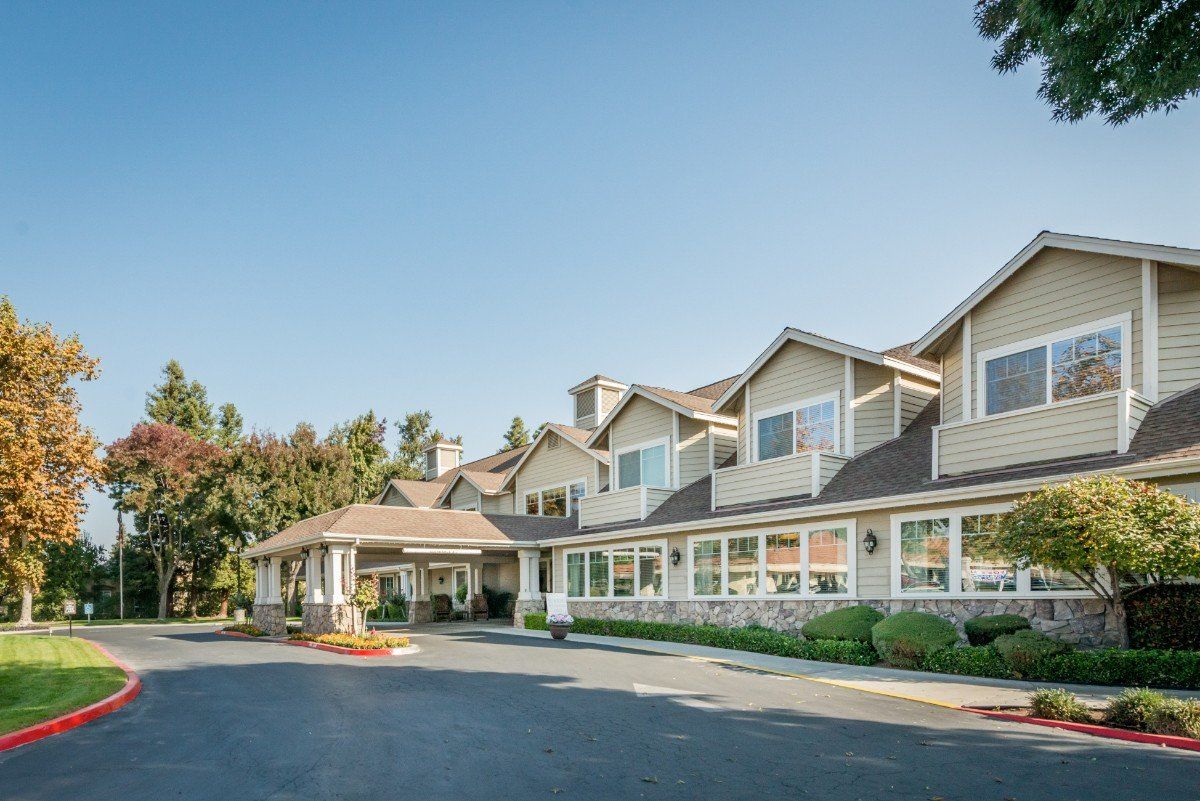 A scenic view of a modern hotel building with a landscaped exterior.